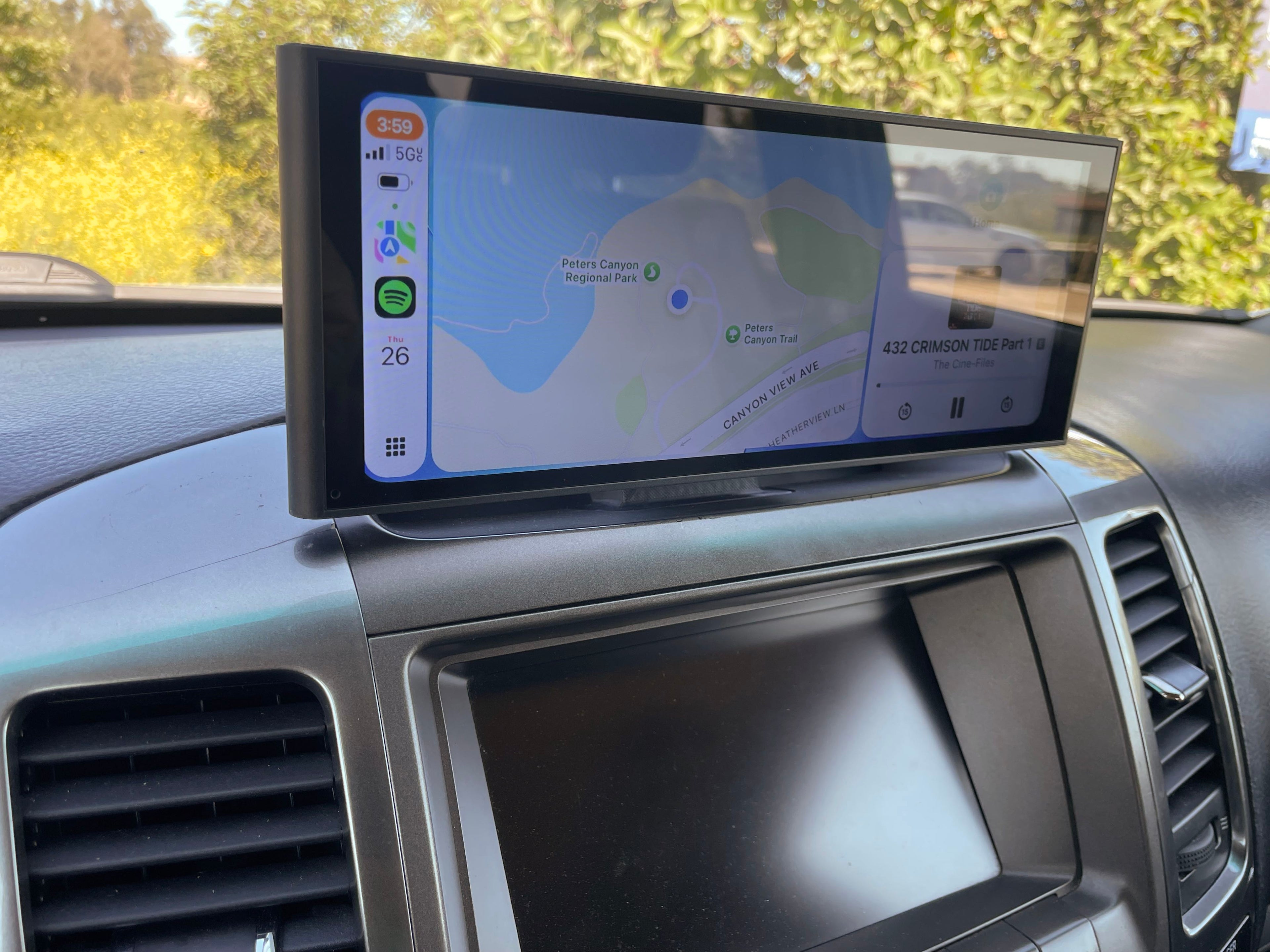 Carplay screen mounted in vehicle displaying carplay widgets