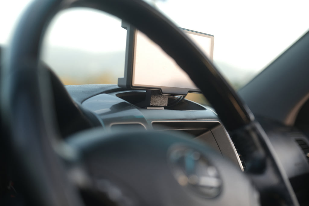 View through the steering wheel of an installed Carplay mount and screen.