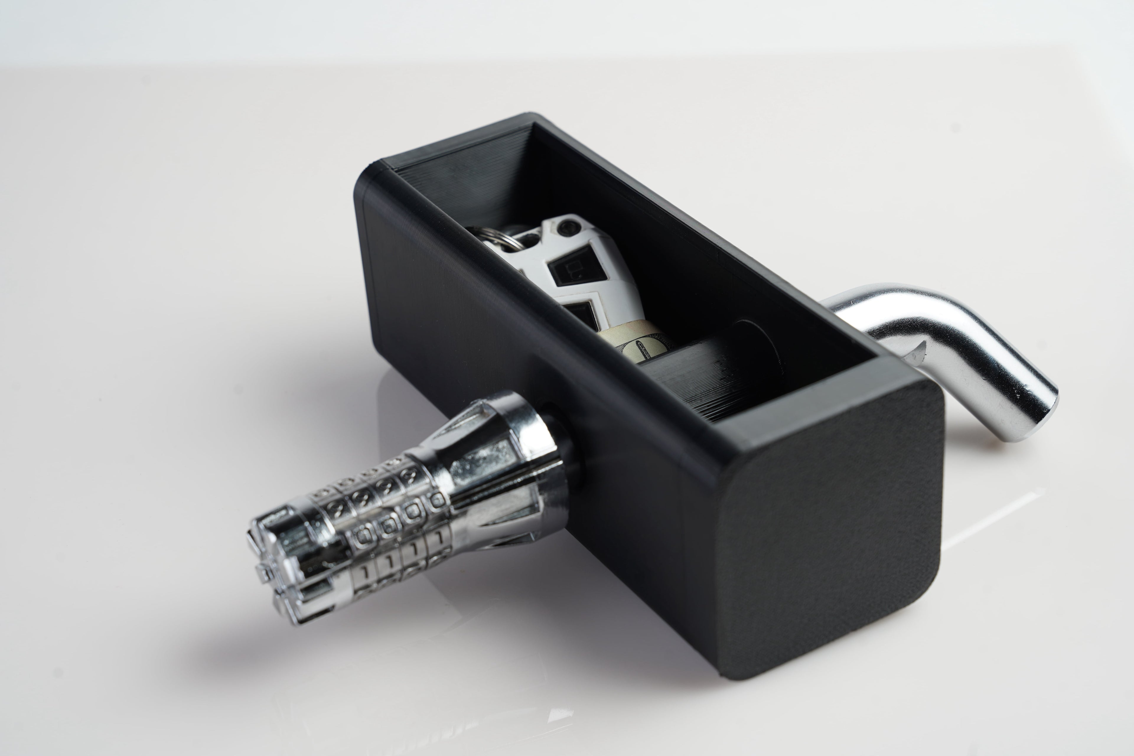 Image showing hitch stash with sample contents and a combination lock hitch pin. The lock hitch pin is not included.