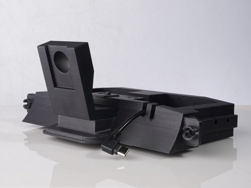 Front quarter view of an uninstalled Carplay mount in black on a white background
